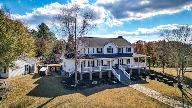 farmhouse-style home with covered porch and a front yard