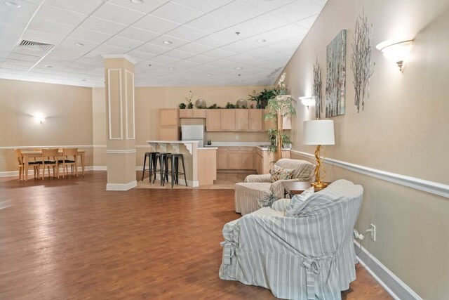 1501 Clairmont Rd Unit 223, Decatur, GA 30033 - sitting room with a drop ceiling, decorative columns, and light wood-type flooring