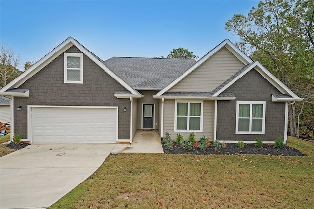 craftsman-style home with a shingled roof, concrete driveway, and a front lawn