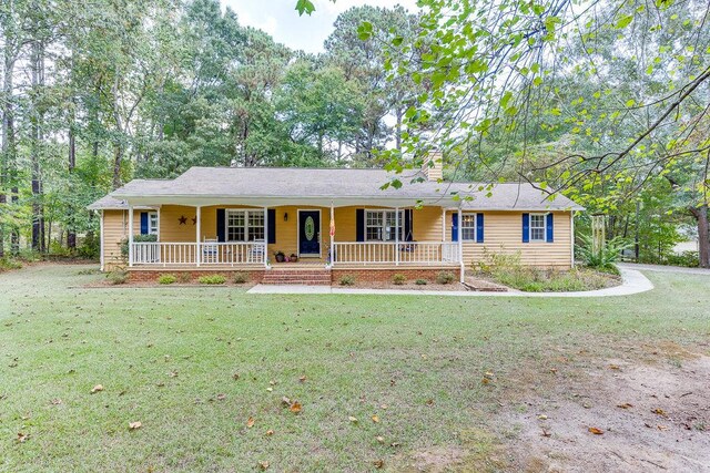 ranch-style house with a porch and a front yard