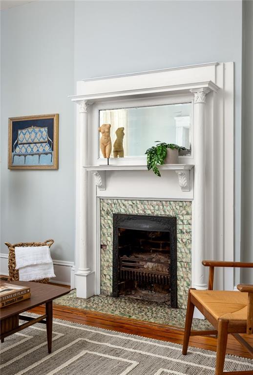 sitting room with wood-type flooring and a fireplace