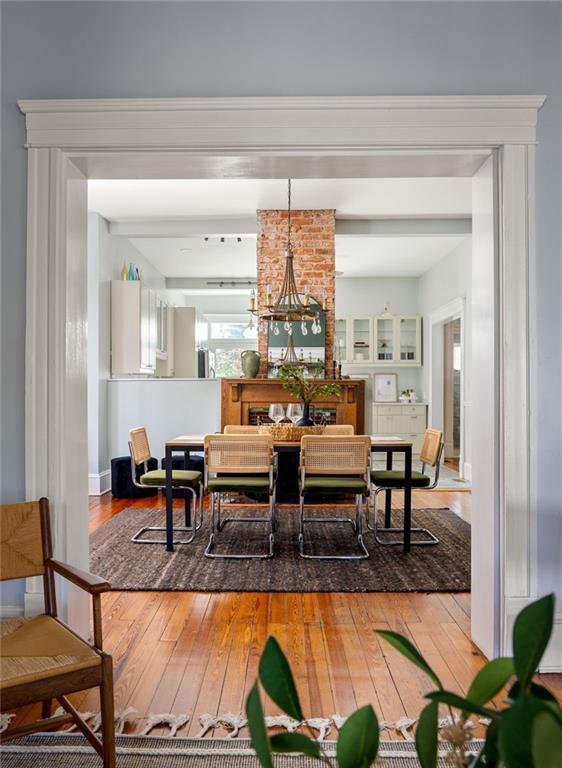 dining area with hardwood / wood-style floors and a chandelier