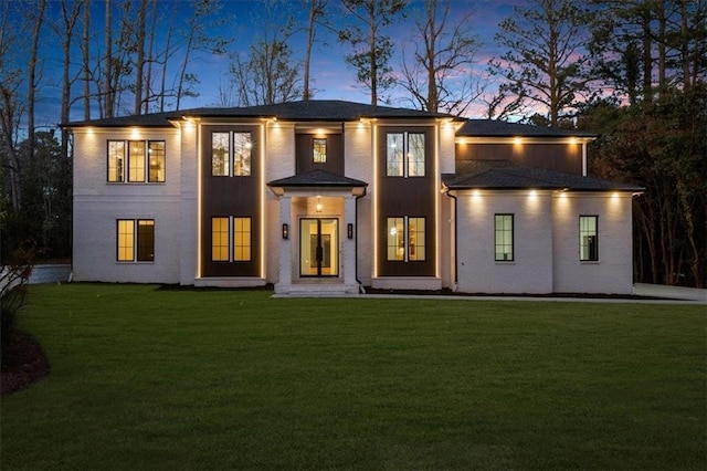 rear view of house featuring a yard