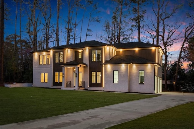 view of front of property featuring a front yard and concrete driveway