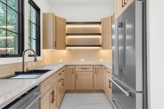 kitchen featuring light brown cabinets, appliances with stainless steel finishes, and a sink