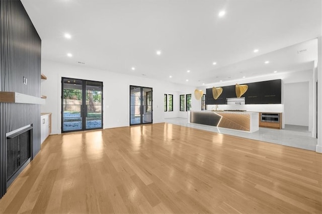 kitchen featuring a sink, modern cabinets, light countertops, appliances with stainless steel finishes, and recessed lighting