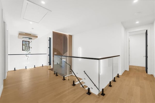 unfurnished living room with light wood-type flooring, a wealth of natural light, and ornamental molding