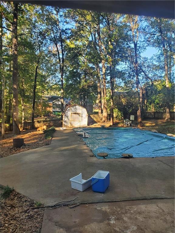 3905 Hunters Chase, Conyers, GA 30094 - view of pool featuring a covered pool, fence, and a patio area
