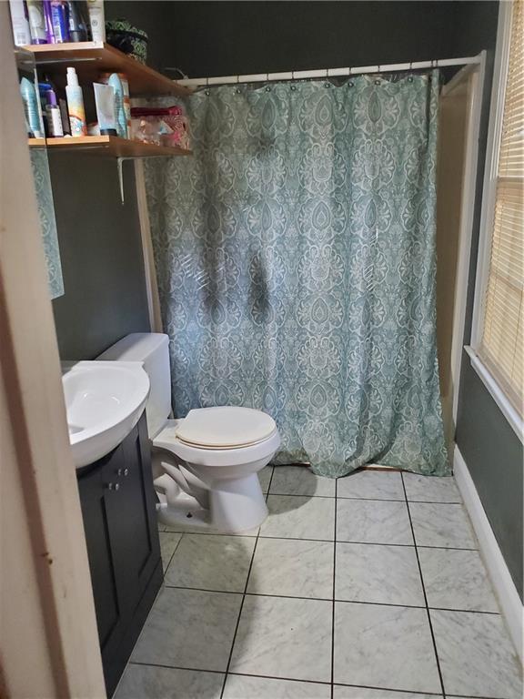 3905 Hunters Chase, Conyers, GA 30094 - bathroom featuring toilet, tile patterned floors, vanity, and curtained shower
