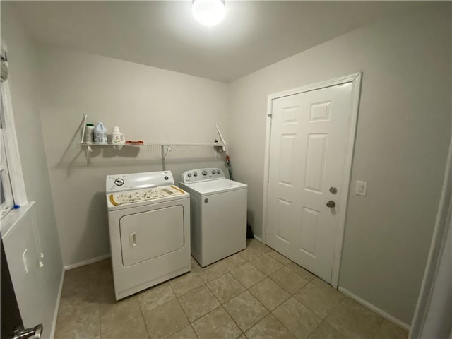 washroom with light tile patterned floors and washing machine and clothes dryer