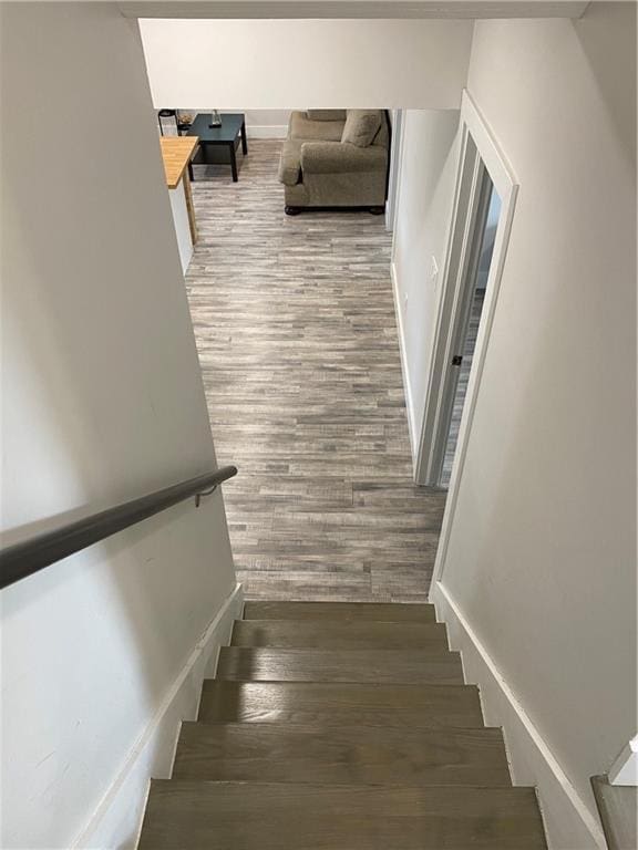 staircase with hardwood / wood-style floors