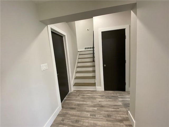 hallway with hardwood / wood-style floors