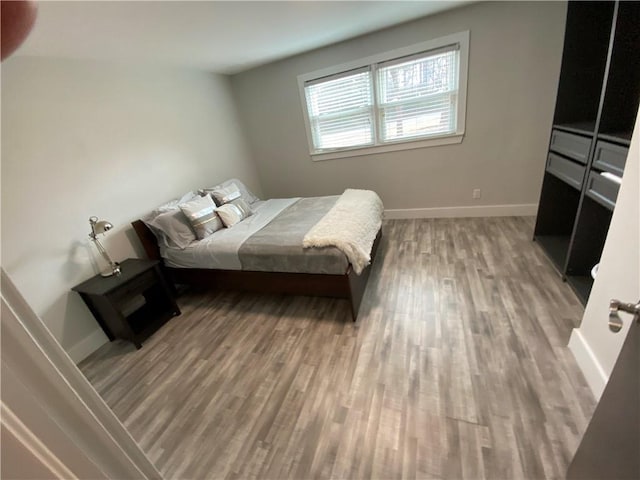 bedroom with wood-type flooring