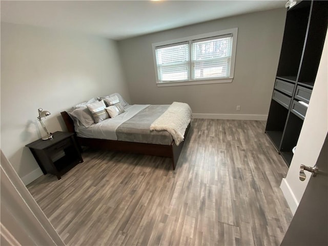 bedroom with dark hardwood / wood-style flooring