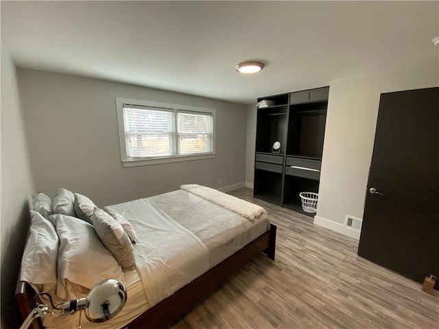 bedroom with wood-type flooring