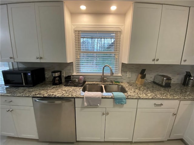 kitchen featuring sink, white cabinetry, light stone countertops, decorative backsplash, and stainless steel dishwasher