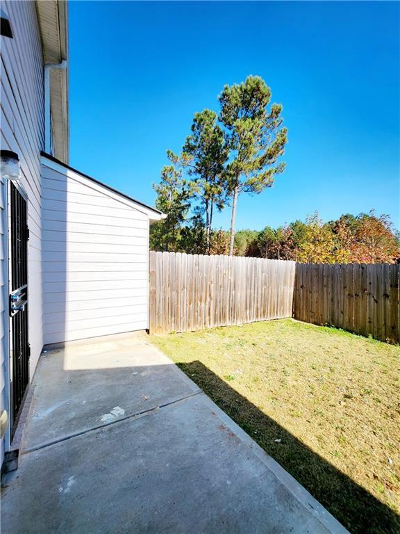 view of yard featuring a patio and a fenced backyard