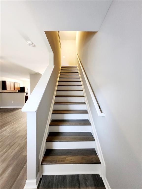 stairway featuring wood finished floors