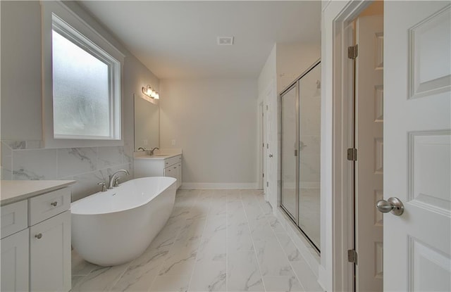 bathroom with vanity and shower with separate bathtub