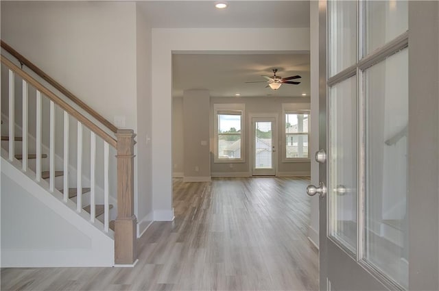 entryway with ceiling fan and light hardwood / wood-style floors