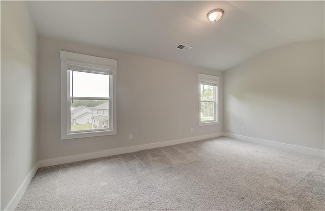 unfurnished room with carpet and lofted ceiling