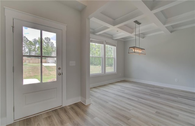 doorway to outside featuring beamed ceiling, light hardwood / wood-style floors, and coffered ceiling