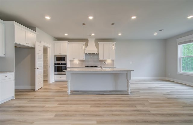 kitchen featuring white cabinetry, a kitchen island with sink, and appliances with stainless steel finishes