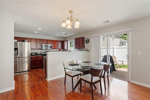 3698 Roseman Lndg, Cumming, GA 30040 - dining area with a chandelier, recessed lighting, dark wood-style flooring, baseboards, and a textured ceiling