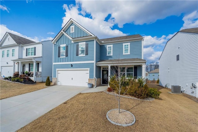 view of front of house featuring a garage, a front yard, cooling unit, and covered porch