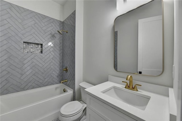 full bathroom featuring vanity, tiled shower / bath combo, and toilet