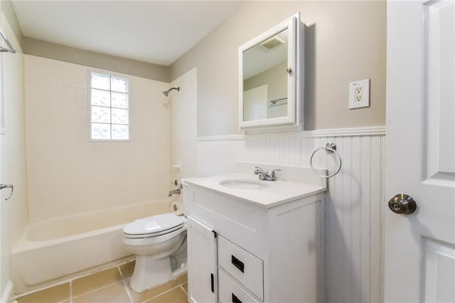 full bathroom featuring tile patterned flooring, tiled shower / bath combo, toilet, and vanity