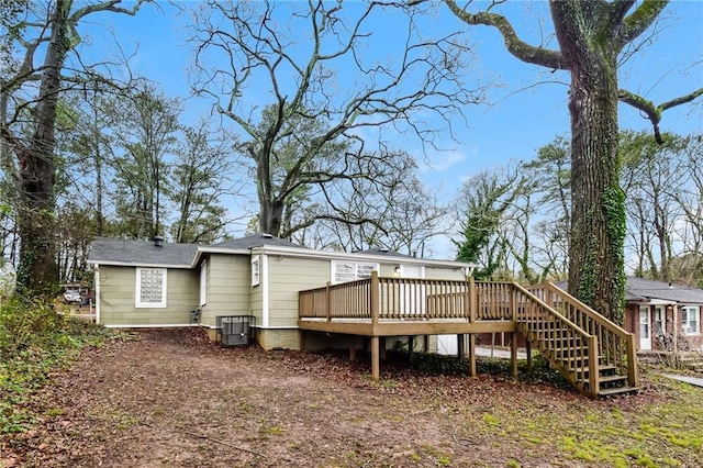 rear view of house featuring central AC and a deck