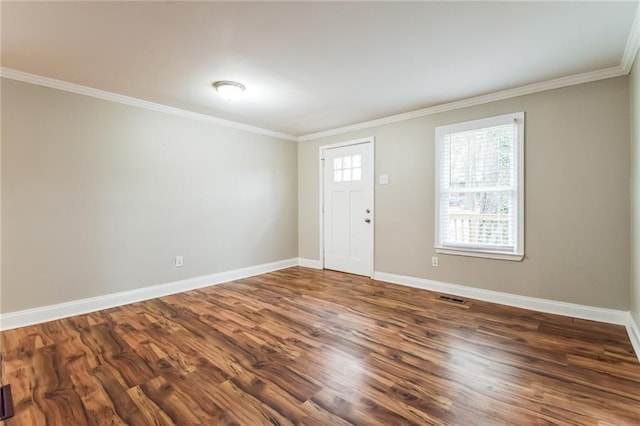 foyer entrance with dark hardwood / wood-style floors and ornamental molding