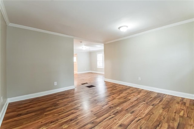 unfurnished room featuring wood-type flooring and ornamental molding