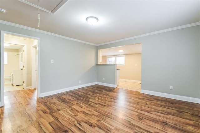 empty room featuring light hardwood / wood-style floors and ornamental molding