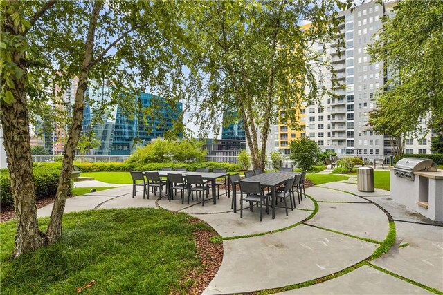 950 W Peachtree St NW Unit 904, Atlanta, GA 30309 - surrounding community featuring a lawn and a patio