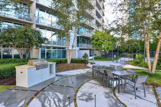 view of patio / terrace featuring area for grilling, fence, and outdoor dining space