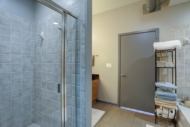 bathroom featuring tile patterned flooring and a shower with shower door