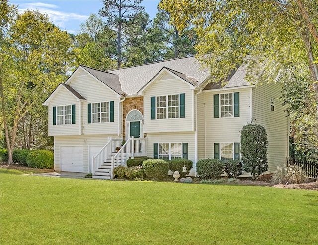 split foyer home featuring a garage and a front yard