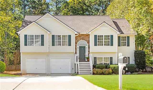 bi-level home featuring a front yard and a garage