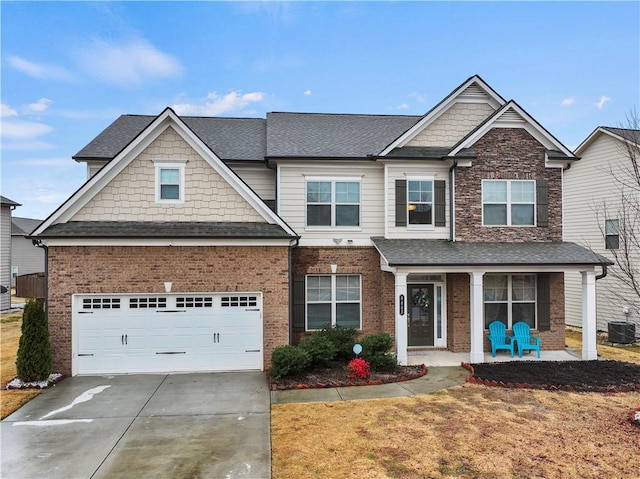 craftsman-style house featuring cooling unit, a garage, and a porch