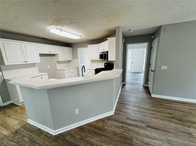 108 Northcutt Station Pl, Acworth, GA 30101 - kitchen featuring black range with gas cooktop, stainless steel microwave, dark wood-style flooring, baseboards, and a sink