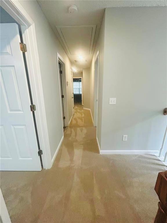 108 Northcutt Station Pl, Acworth, GA 30101 - hallway featuring attic access, light colored carpet, and baseboards