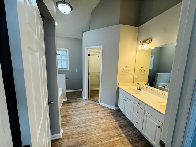 108 Northcutt Station Pl, Acworth, GA 30101 - full bathroom with double vanity, wood finished floors, a tub to relax in, baseboards, and high vaulted ceiling