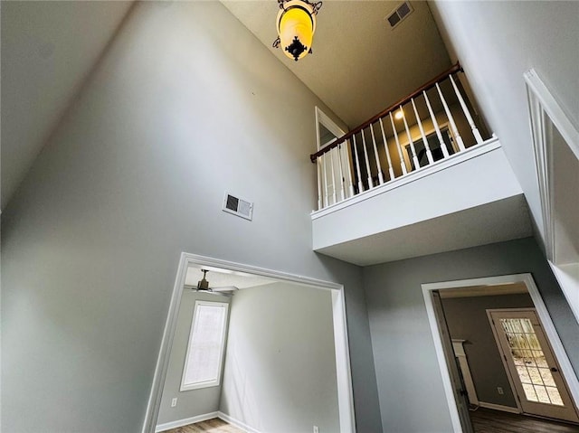 108 Northcutt Station Pl, Acworth, GA 30101 - stairway with a high ceiling, a ceiling fan, healthy amount of natural light, wood finished floors, and baseboards
