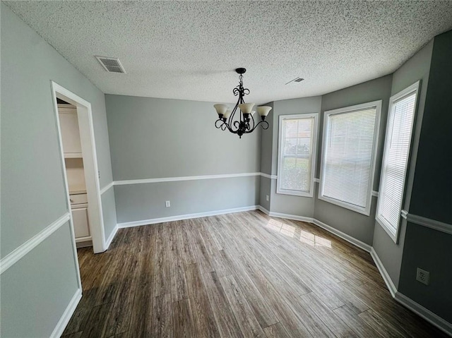 108 Northcutt Station Pl, Acworth, GA 30101 - unfurnished dining area with wood finished floors, plenty of natural light, a chandelier, a textured ceiling, and baseboards