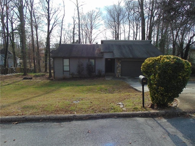 mid-century inspired home featuring a garage, stone siding, a front lawn, and driveway