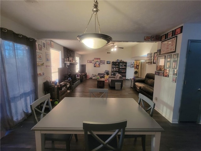 dining area featuring lofted ceiling, dark wood-type flooring, and ceiling fan