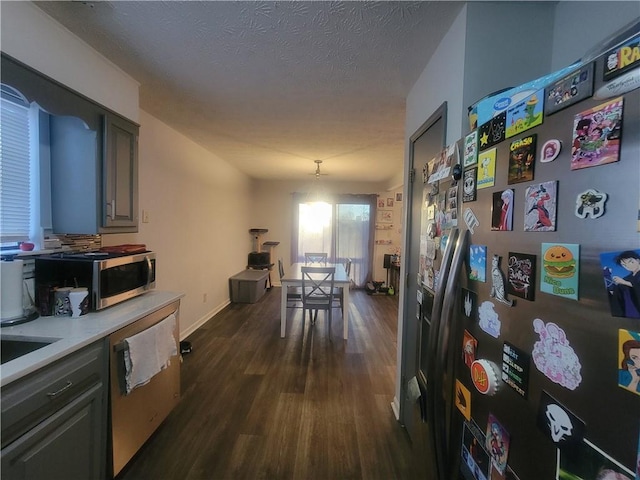 interior space with gray cabinets, appliances with stainless steel finishes, dark hardwood / wood-style floors, and a textured ceiling