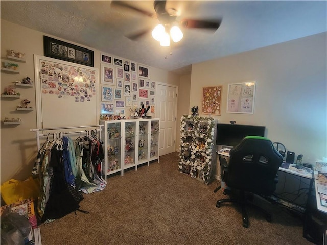 carpeted office featuring ceiling fan